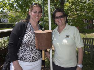 Kathy Newcomb, senior vice president of marketing in client services for Coldwell Banker Resort Realty, left, is joined by Pat Coluzzi, Rehoboth Farmers Market Master, to ring in the opening. BY DENY HOWETH