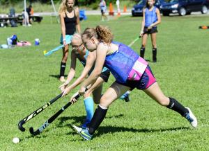 Maggie Mitchell, 12, left, from Sussex Academy, battles for possession with Annabelle Miller, 13, from Ursuline Academy. BY DAN COOK