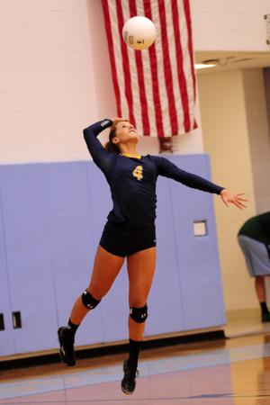 Senior Kira Vitella serves an ace. BY DAN COOK