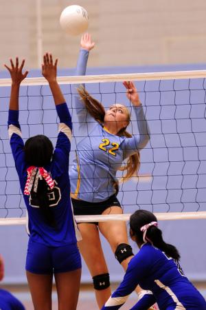 Senior Cameron Wick scores a kill for the Lady Vikings. BY DAN COOK