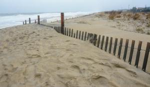 Blowing sand has filled in a crossover near the south end of the Rehoboth Beach Boardwalk. BY RON MACARTHUR
