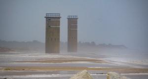 Wind-driven waves cover the beach near the World War II towers in Cape Henlopen State Park. BY RON MACARTHUR