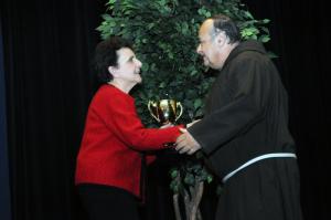 Brother Ronald Giannone was presented with the Stanford L. Bratton Award. Giannone has been instrumental in establishing a great number of housing, health, and job placements all under the umbrella of his Ministry of Caring. Shown presenting the award to Giannone is Board President Peggy Strine. BY STEVEN BILLUPS