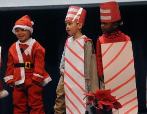 The peppermint sticks are joined by Santa as they sing "My Peppermint Stick." Shown are (l-r) Javien Diehl, Matthew Nguyen and Kamara Wright. BY STEVEN BILLUPS