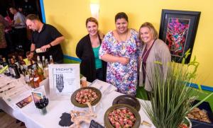 Michy's offered a full flavor bite, (l-r) Brandy Rehkamp, Viviane Morrison and owner Michelle Davis are all smiles while serving the spicy seared beef tenderloin. BY DENY HOWETH