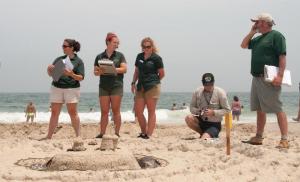 Delaware Seashore State Park officers, interpreters and interns head down the beach for sand castle sculpture judging (l-r) Kendall Sommer, stewardship administrator; Casey Brotman, interpreter; Lexi Lebeau, seasonal intern; Doug Long, park supervisor, Pat Cooper, administrator. DENY HOWETH PHOTO