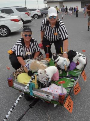 Dewey, Hobie and Bethany are on the gridiron as their owners Tina Maddox, left, and Sue Green of Glen Burnie, Md., watch from the sidelines. RON MACARTHUR PHOTO