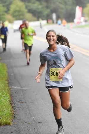 Anna Stancofski, 14, of Lewes is all smiles as she rounds the final turn. NICK ROTH PHOTO