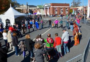 Members of the Nanticoke tribe gather Return Day attendees to join them in dance on The Circle. RON MACARTHUR PHOTO