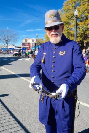 Jim Bowden, vice president of the Return Day Committee, has antique handcuffs ready for people who call the event “Returns Day.” RON MACARTHUR PHOTO