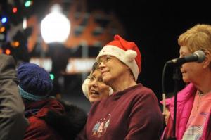 Village Improvement Association members lead the large crowd signing Christmas songs. From the left are Linda Crowe, Kathy Osterholm and Patt Madison-Gauger. RON MACARTHUR PHOTO
