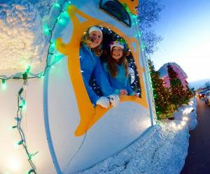 Faith Hanlon, left, and Adley Triscuit peer out the window of the Schellville float. RON MACARTHUR PHOTO