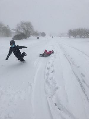 Victor Goodhue, 9, took a spill while pulling his sister Caitlin, 6, on her sled in Milton. AMY GOODHUE PHOTO