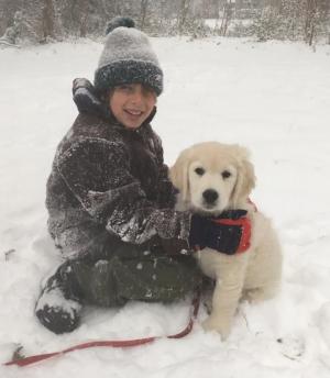 Jack Shockley of Lewes with his puppy, Buster. Buster enjoyed seeing snow for the first time. ELLEN JONES PHOTO