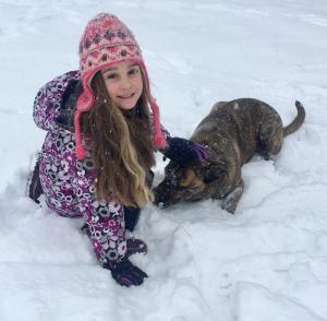 Brinley Brosius with her puppy Mack, who is having fun playing in his first snow. ANDREA BROSIUS PHOTO