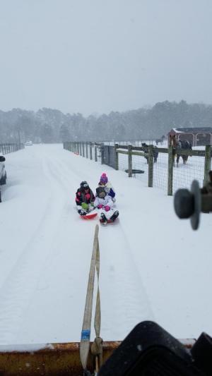 Lina Jensen, Katy Stumpo and Ava Stumpo enjoy the snow day at Hope for Success Farm in Milton. KATHY JENSEN PHOTO