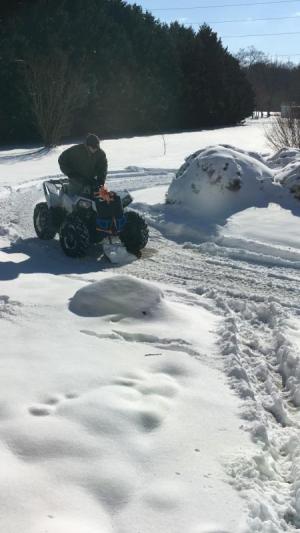 What happens when you don’t have a snow plow? Emmett Capano ties a shovel to an ATV to get the job done. JEANNE KNOWLES PHOTO