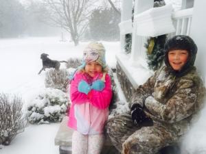 Jase and Jorja Truitt of Rehoboth enjoy the first snowfall of 2017 while dog Drake frolics in the background. SUSANNE TRUITT PHOTO