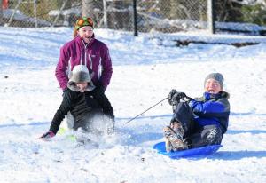 Sledders enjoy the hill on Chandler Street in Milton. Shown are (l-r) Lindsey Rambo, 14, McKenna Boyle, 11, and Kelly Bragg,12. DAN COOK PHOTO