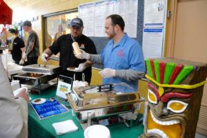 Anthony Jacona, left, and Alex Hudson of Zogg’s Sea Hogg prepare a plate of wings as a fan favorite in the Fire and Ice wings competition.