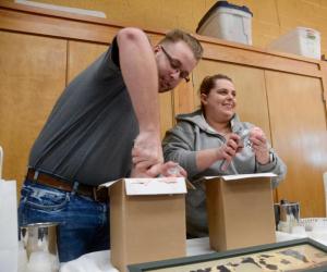 Rodney Wilson Jr. and Libby Seaman scoop out some Hopkins Creamery ice cream, selected as the fan favorite in the Fire and Ice contest.
