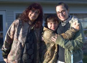 Lifelong Milton resident Carol Mast, left, joins her children Douglas and Allie for a photo outside their home off Route 16.