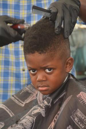 It’s hard to tell whether Jerry Smith III is happy or not that he’s getting his hair cut in time for the first day of school.