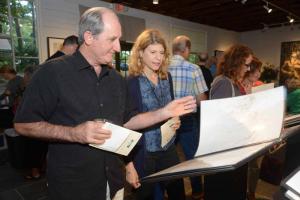 Browsing through the pages of one of Raubacher’s sketch books are Hal and Alyssa Chapman. RAL Raubacher