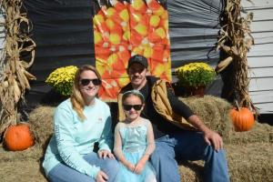 Posing on a fall-themed backdrop with a princess are (l-r) Candice Windsor, Skylee Kinsler and Chris Kinsler. Fall Festival
