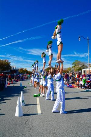 The cheer team from Wilmington University goes up in the air to perform a routine. RON MACARTHUR PHOTO
