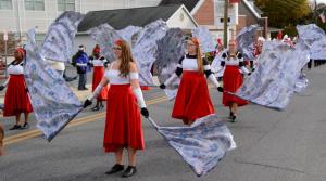 The Laurel High School marching band color guard puts on a show on the parade route along Central Avenue. RON MACARTHUR PHOTO