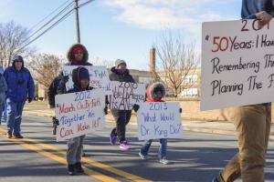Youngsters marching with Faith U.M. Church of Rehoboth ask “What would Dr. King do?” and “ March on by Faith: Together we can make it!”