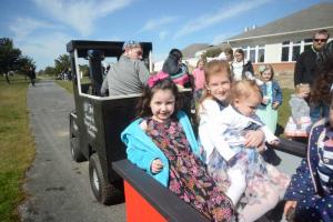 Riding the Historic Georgetown Association Lil’ Toot are (l-r) Kennedy and Brooklyn Miller holding Alexandra Spriggs. GT Easter Egg Hunt