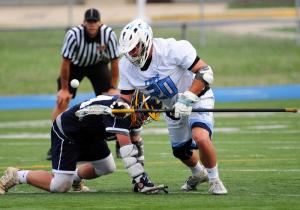 Cape senior long pole middie Liam Zolper wins a face-off over Sanford’s Tim Lucky.