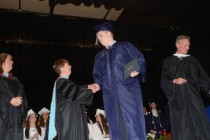With his diploma in hand, Bradley Ryall from Bethany Beach shakes the hand of Director Dr. Patricia Oliphant. Sussex Academy grads