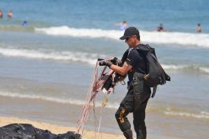 The Ocean City beach provides a unique setting for pilots and parachutists. A member of the U.S. Special Operations Command Parachute Team gets his gear together after a jump on the beach.