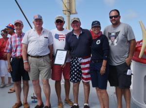 JR Squared took first place in the parade. Shown are (l-r) Albert Didden, president of the Overfalls Foundation; Mayor Ted Becker; captains Jim Ruth and Jim Rivette; Bev Rosella, Freedom Boat Club; and Jason Scott Bentley, president of the Rotary Club of Lewes-Rehoboth.
