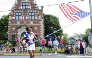Diana Hoenen leads the annual Doo-Dah Parade in downtown Lewes swinging the American flag. DENY HOWETH PHOTO