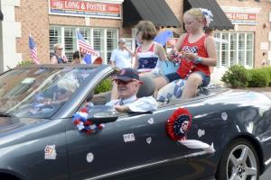 Bill Schab leads the Greater Lewes Community Village in the float with Madison and Makenna Stahl perfection their candy throw. DENY HOWETH PHOTO