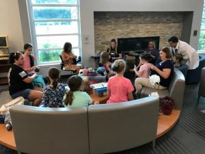 Knitters of all ages and experiences gather by the fireplace at the Lewes Library to work on wool helmet liners for military troops overseas.