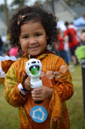 Natalia Mansfield, 2, shoots bubbles during Zombie Fest.