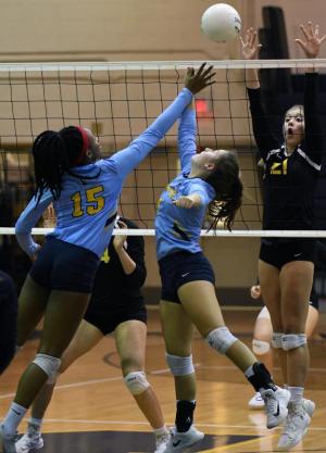 Mikiyah Ennals, left, and Abbey Derrickson win a joust with Padua’s Michelle Kozicki.