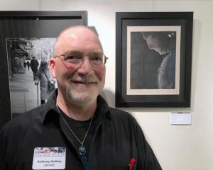 Anthony Chiffolo is shown with his watercolor “Bear Silhouette.”