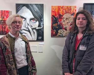 Posing in front of their works are artists Hal Nearing, left, and Viva D'Anna.