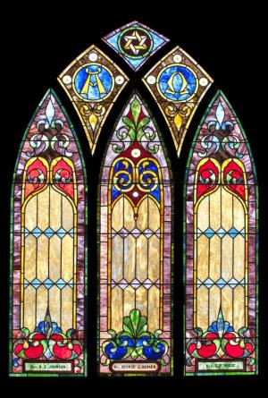 Stained-glass windows, circa 1906, on the east wall of Milton Historical Society’s Lydia B. Cannon Museum honor pastors of the Methodist church formerly housed in the building.