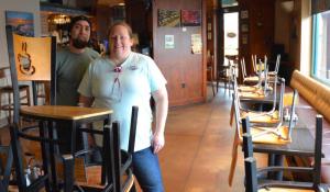 Shown here are Arena’s Five Points General Manager Katy Miller and Kitchen Manager Marcello Guandique say the chairs are up in the dining room, but take out is available.