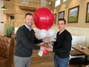 Dr. Roberto Scaffidi, right, Southern Delaware Heart Walk 2022 chair, receives an award of thanks from Dave Morris, American Heart Association executive director.