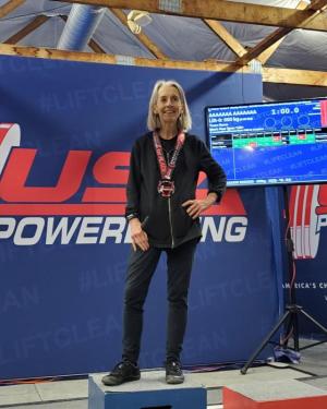 Jennine Anderson stands alone on the podium after setting four new American Powerlifting records.
