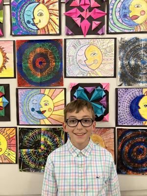 Milton Elementary School fifth-grader Maurizio Retzlaff stops for a photo beside some of the visual arts on display. SUBMITTED PHOTOS