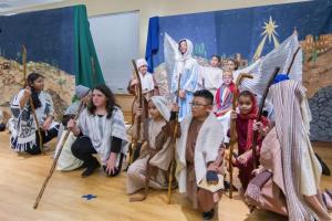 Shepherds come to see the newborn child during the annual "Darkness into Light" Nativity pageant. Behind the shepherds are Mary (Iyanna Johnson), archangels Michael and Gabriel (Joseph Ohri and Angelina Rodriguez) and Joseph (Lane Carter). Shepherds are (not in order) MariaClara Almeida, Liam Carter, Krystell Marin, Henry Morales-Yoc, Alex Nickerson, Megan Krajewski, Mary Bishop and Claire Connelly.